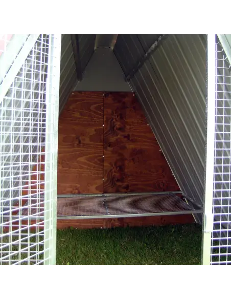 Interior of galvanized steel ground chicken coop with perch
