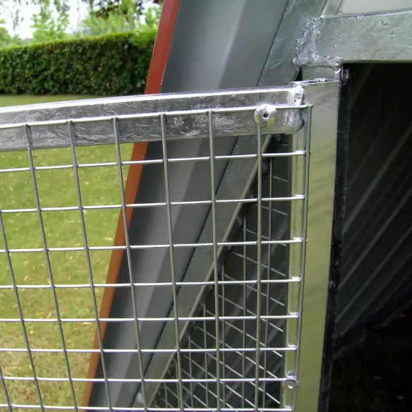 Door of ground chicken coop with locking latch and padlock fitting